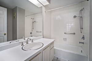 Bathroom featuring vanity and tiled shower / bath