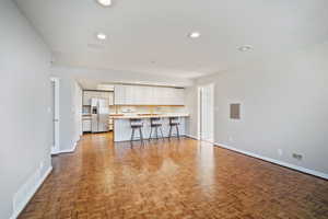 Unfurnished living room with light parquet flooring