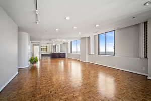 Unfurnished living room with dark parquet floors