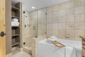 Bathroom featuring tile patterned floors, shower with separate bathtub, built in features, and vanity