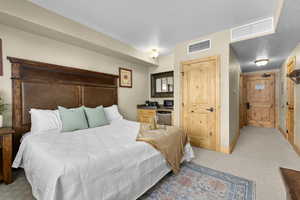 Carpeted bedroom with a textured ceiling