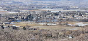 Birds eye view of property with a water view