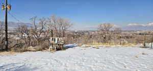 Yard covered in snow with a mountain view