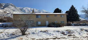 Snow covered property featuring a mountain view