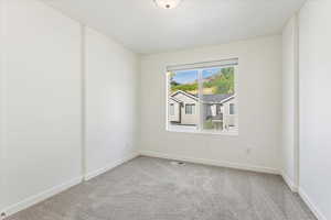 Spare room featuring light colored carpet