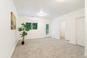 Empty room with light colored carpet