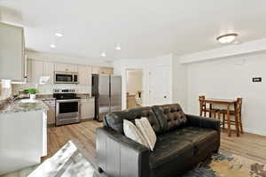 Living room with sink and light wood-type flooring