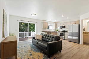 Living room featuring sink and light hardwood / wood-style floors