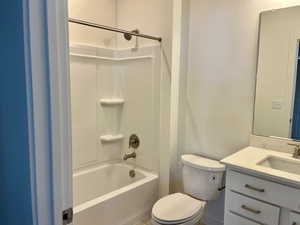 Full bathroom featuring shower / bathing tub combination, vanity, and toilet