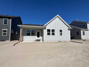 Rear view of house with board and batten siding