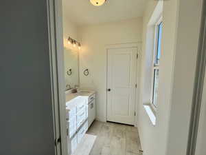 Bathroom with double vanity, baseboards, and a sink