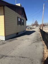 View of side of home with central AC