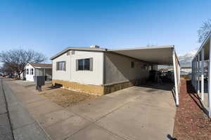 View of property exterior featuring a carport