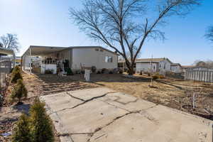 Rear view of property with a carport