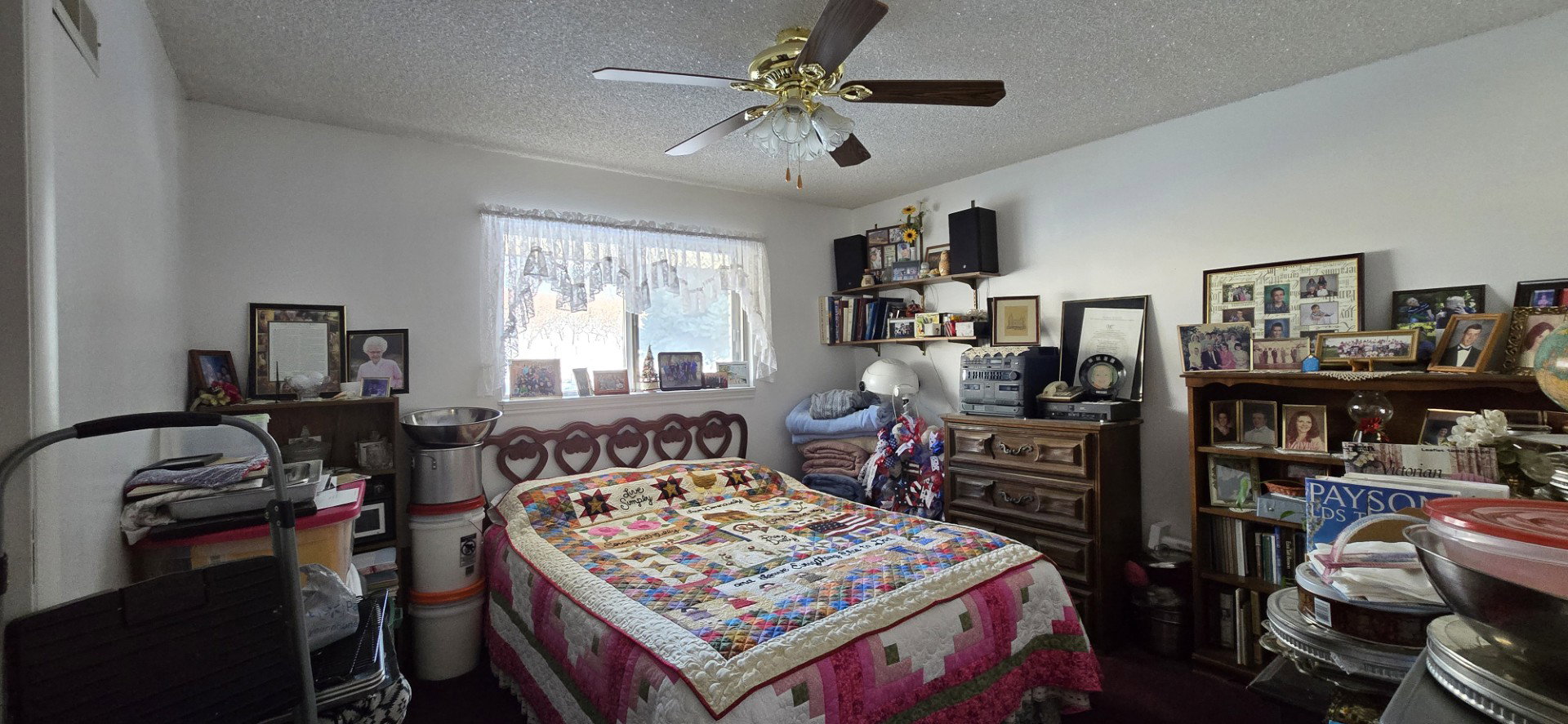 Bedroom featuring ceiling fan and a textured ceiling