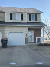 Front facade with a garage and a porch