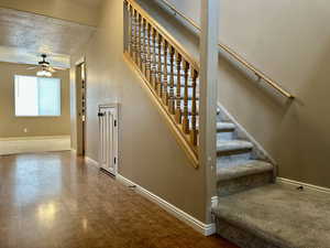 Welcoming entry featuring hardwood / wood-style flooring, a textured ceiling, and ceiling fan