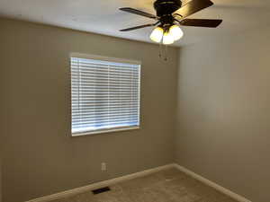 Spare room featuring ceiling fan, carpet flooring, and a textured ceiling