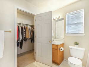 Bathroom featuring tile patterned flooring, vanity, and toilet