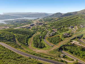 Aerial view of property's location with property parcel outlined and a water and mountain view