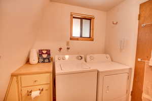 Washroom with washing machine and clothes dryer