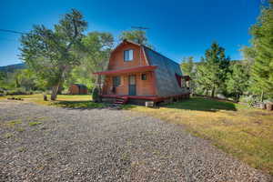 View of front facade with a front lawn and a storage unit