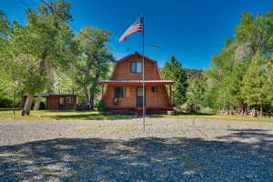 View of front of property featuring an outbuilding and a porch