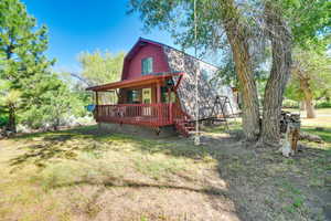 View of front of home with a front yard and a deck