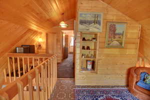 Hall featuring vaulted ceiling and wooden ceiling