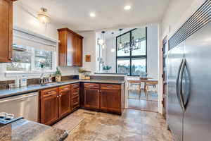 Kitchen has custom wood cabinets and  stainless steel appliances