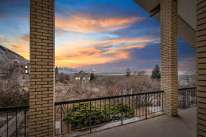 Balcony at dusk featuring a mountain view