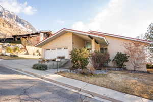 View of front of property featuring a mountain view and a garage