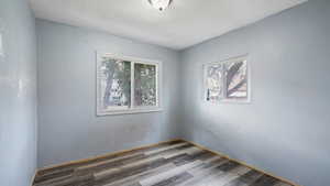 Unfurnished room with hardwood / wood-style flooring