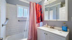 Bathroom with vanity and shower / bath combo