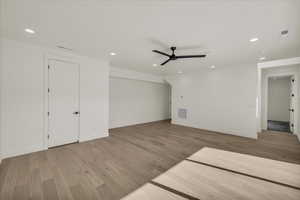 Unfurnished living room featuring ceiling fan and light wood-type flooring