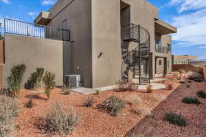 View of side of property with a balcony and central AC unit