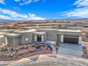 View of front of house featuring a garage and a mountain view