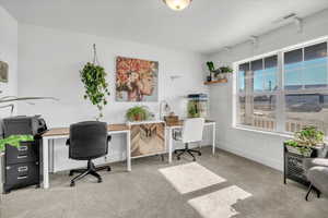 Home office with light colored carpet