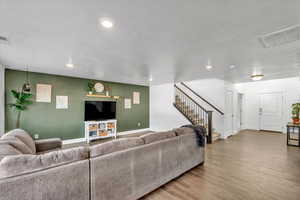 Living room with hardwood / wood-style flooring