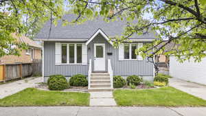 View of front of property featuring board and batten siding and a shingled roof