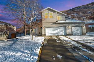 View of front property with a garage and a mountain view