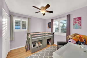 Bedroom with light hardwood / wood-style flooring and ceiling fan