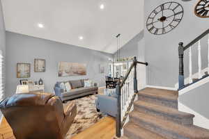 Living room featuring hardwood / wood-style floors and high vaulted ceiling