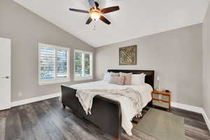 Bedroom with lofted ceiling, dark wood-type flooring, and ceiling fan