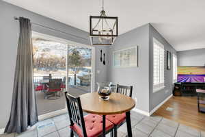 Dining room featuring light tile patterned floors and a chandelier