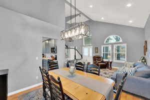 Dining space featuring high vaulted ceiling and light wood-type flooring