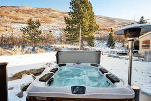 Exterior details with a mountain view and a hot tub