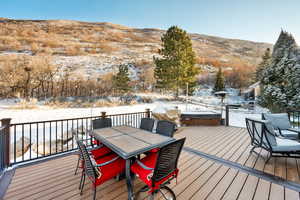 Deck with a mountain view and a hot tub