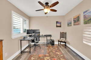 Home office with hardwood / wood-style flooring and ceiling fan