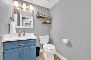 Bathroom with vanity, tile patterned floors, and toilet